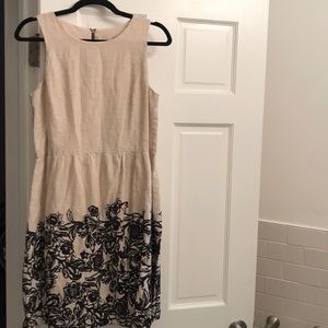 A cream and black fit and flare dress